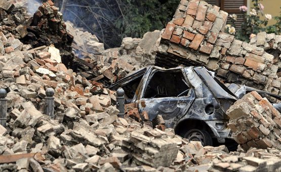 car covered by rubble from the earthquake