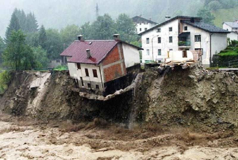 Building that is collapsing due to a landslide