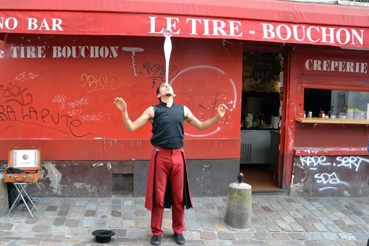 Street artist in front of a club