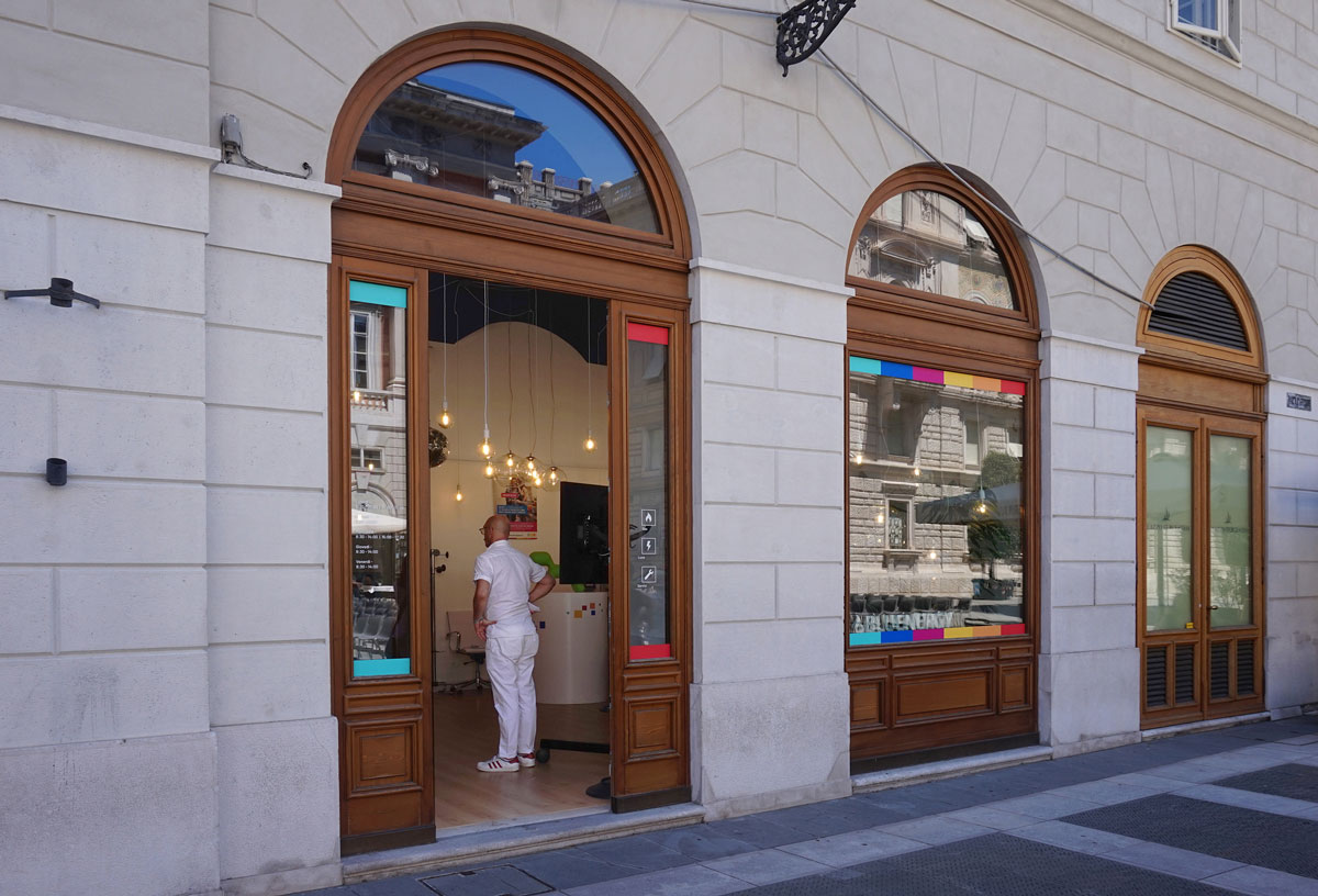 External view of the shop with two large arched windows