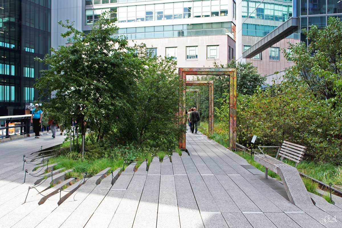 The New York High Line with green area between buildings