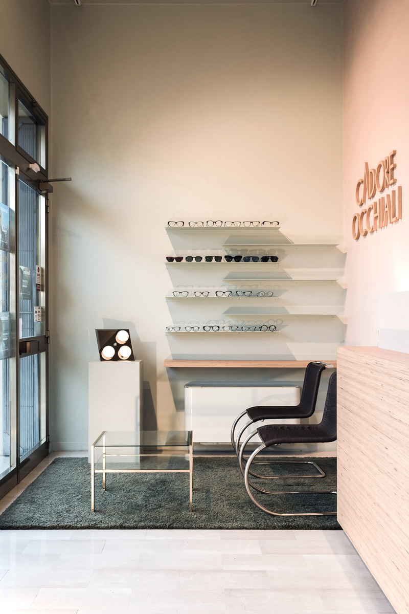 Entrance to the shop leading to the waiting room made up of a small table and a couple of chairs