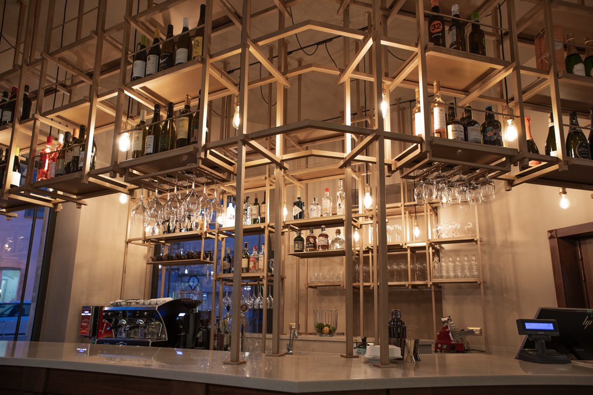 Counter of the restaurant with a wooden structure that supports the various drinks