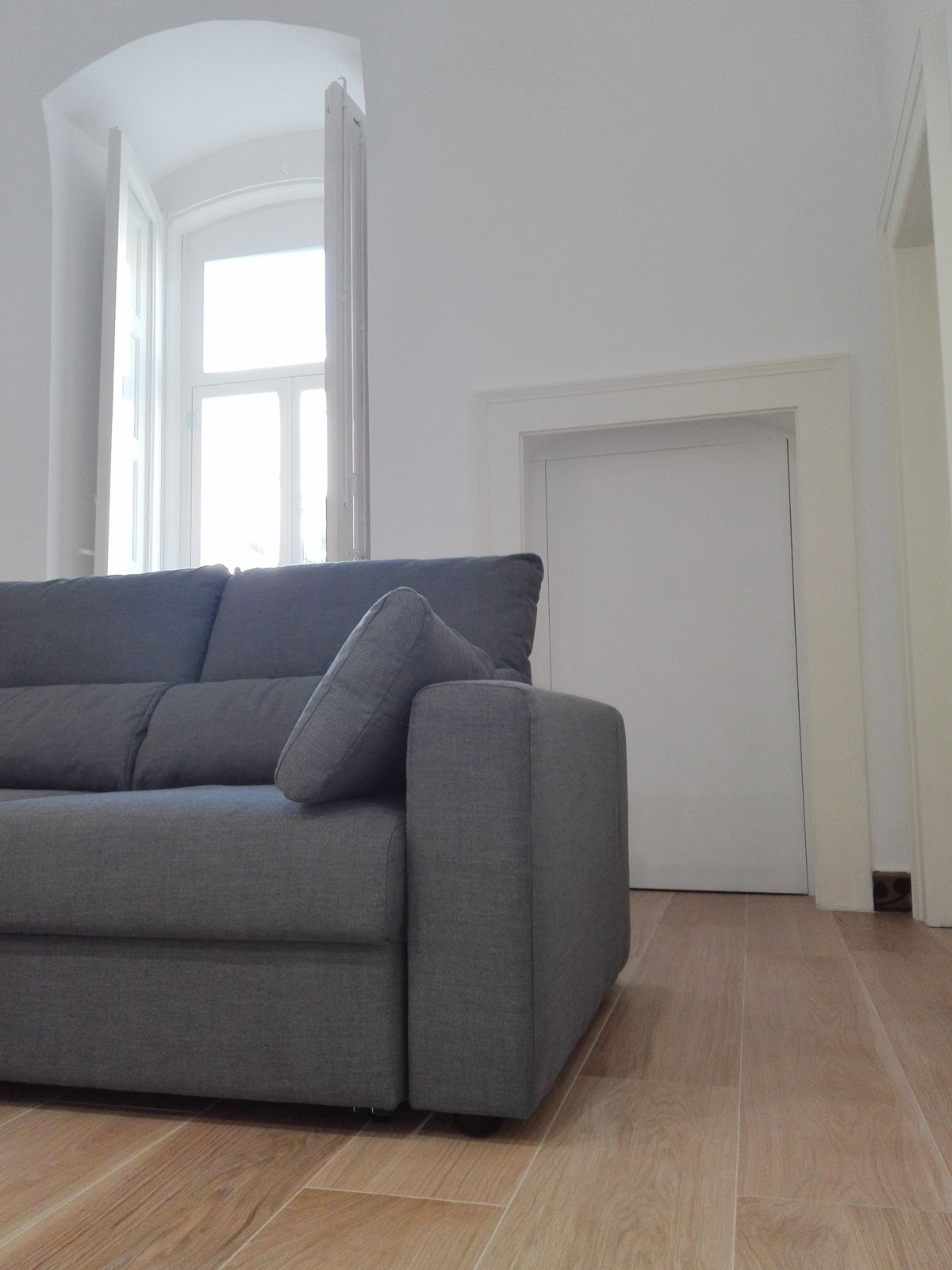 Gray sofa in front of a window