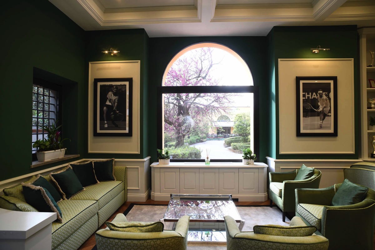Green lounge with a window overlooking the garden
