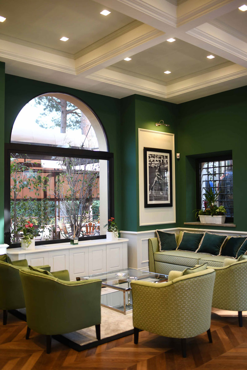 Armchair and green sofas on a sitting area