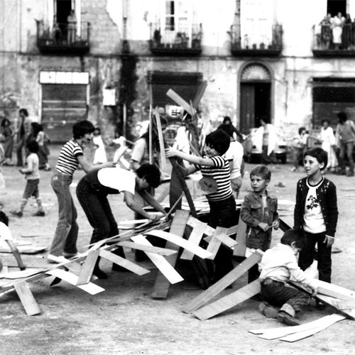 ragazzi che costruiscono un'opera con delle assi di legno