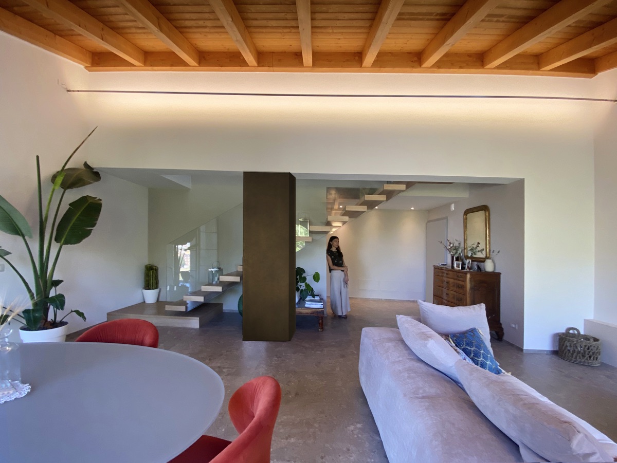 Bright and airy living room of TR House with floor-to-ceiling windows overlooking the countryside, designed by twoPIU architects