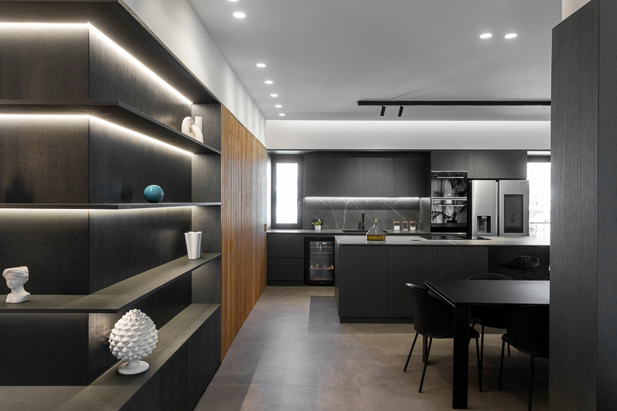 Elegant and modern living and dining room with minimalist black furniture, wood details and light gray sofa, illuminated by natural light